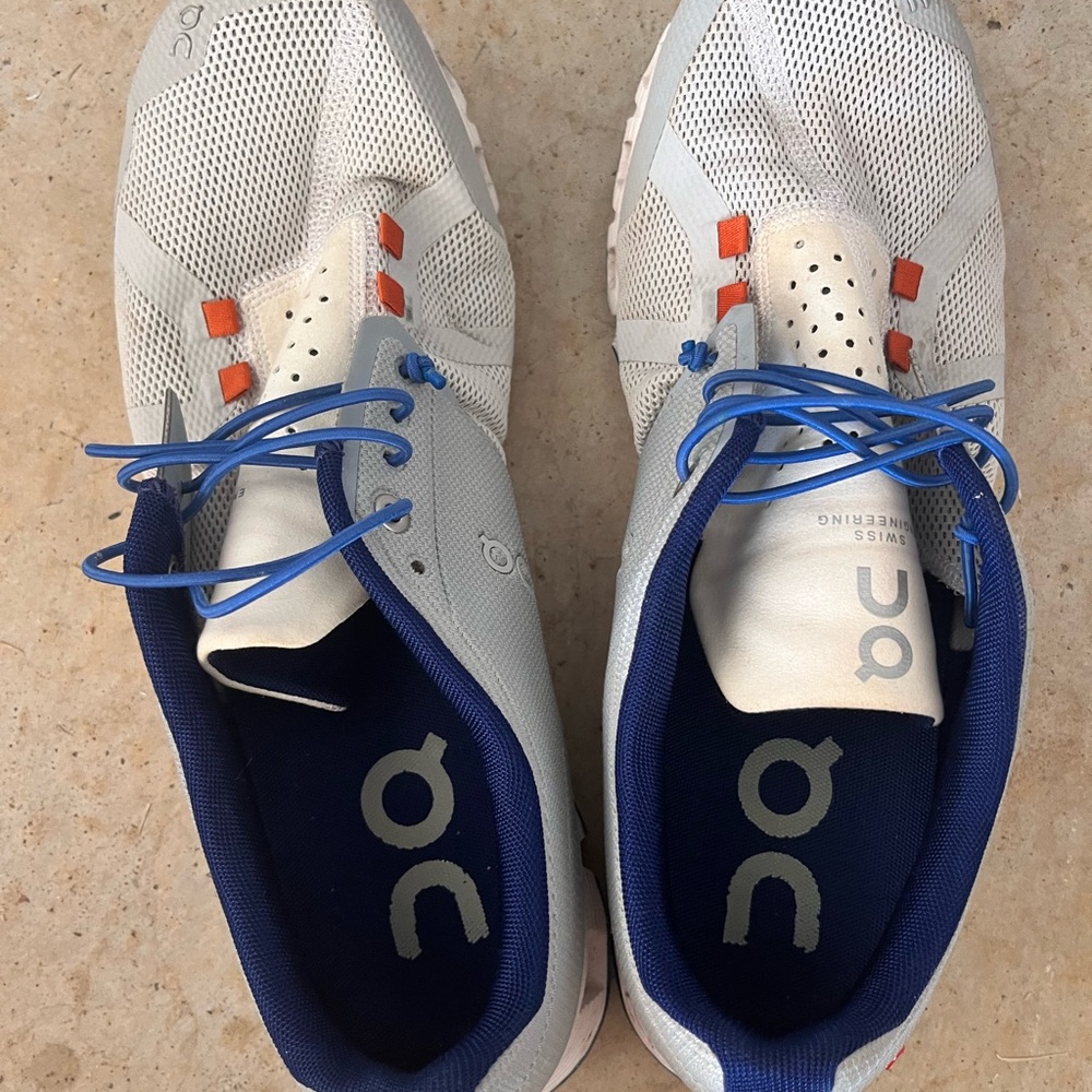 On Running Cream and Blue Athletic Shoes